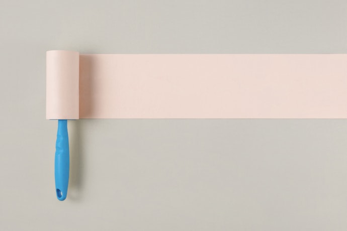 A Manual Lint Remover Has an Adhesive Paper Strip